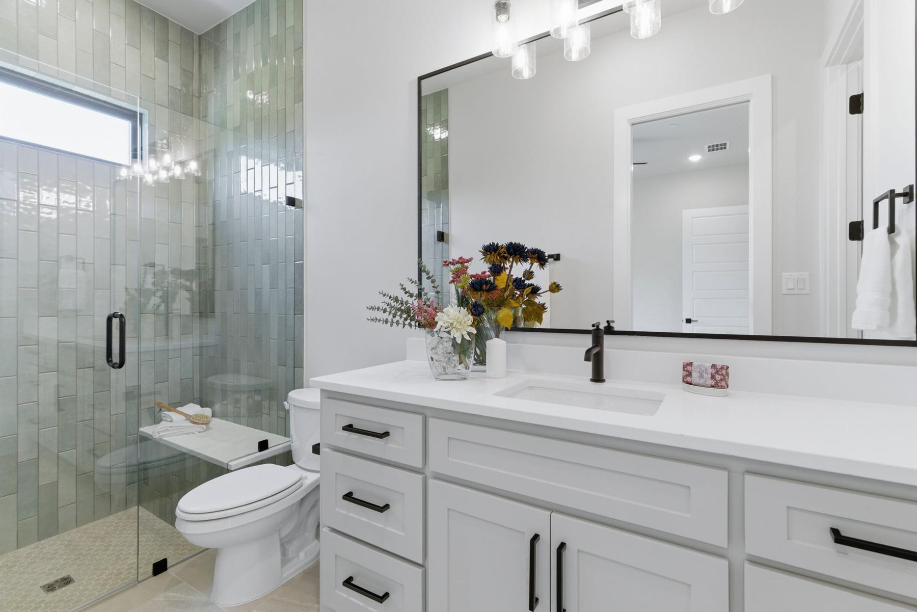 Guest bath green tile shower staged